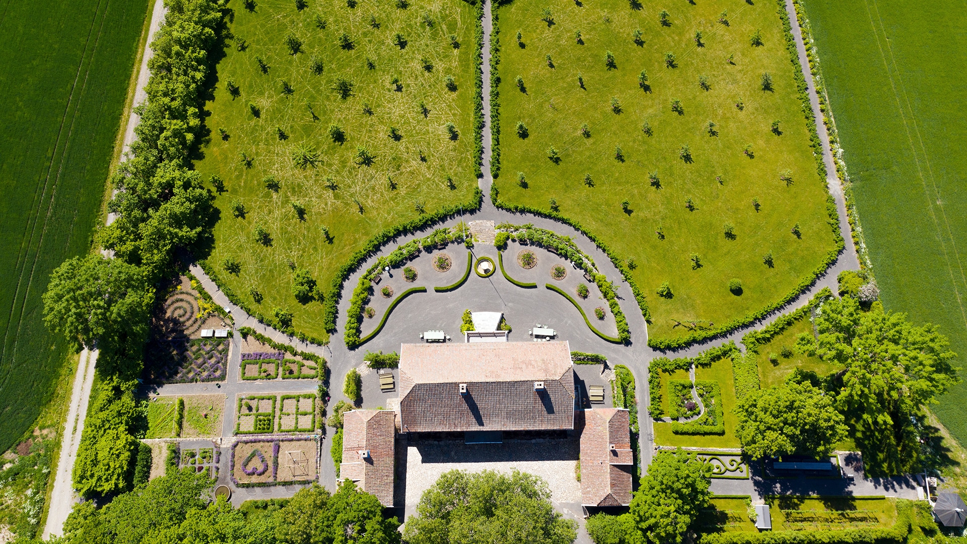 Topshot of the amazing gardens of Hovelsrud farm surrounding the main house on a sunny summer day.